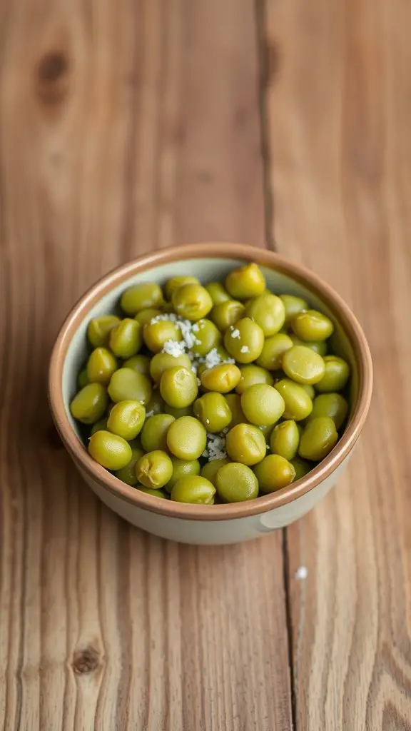 A bowl of edamame sprinkled with sea salt on a wooden table.