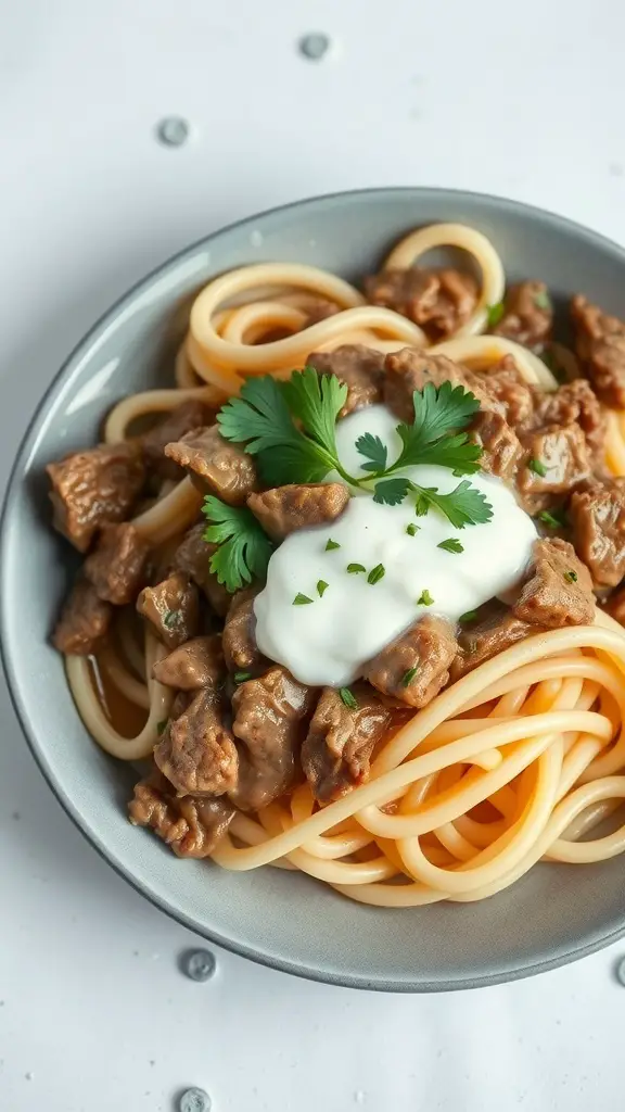 A bowl of beef stroganoff over egg noodles, topped with sour cream and herbs.