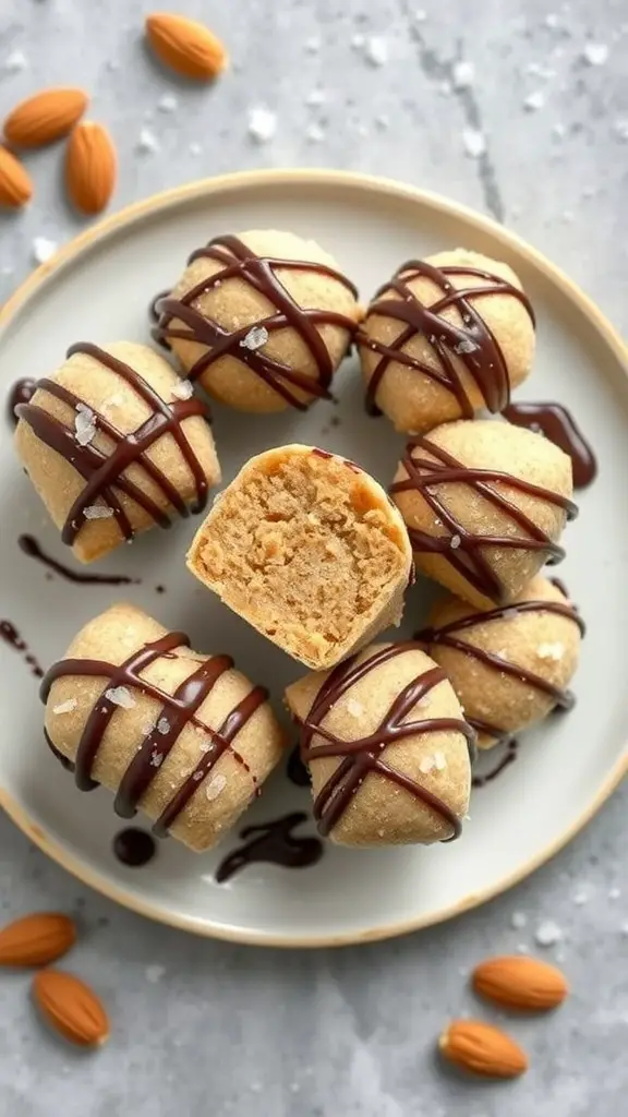A plate of almond butter fat bombs drizzled with chocolate and sprinkled with sea salt, with almonds scattered around.
